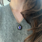 8.46 Pear Tanzanite in Hand Carved Black Jade Lollipop Pendant